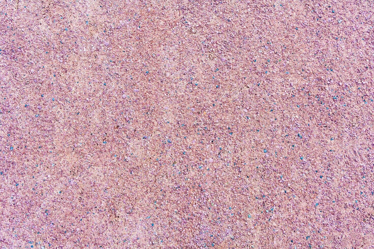 Texture of a gravel path of pink color as background photo