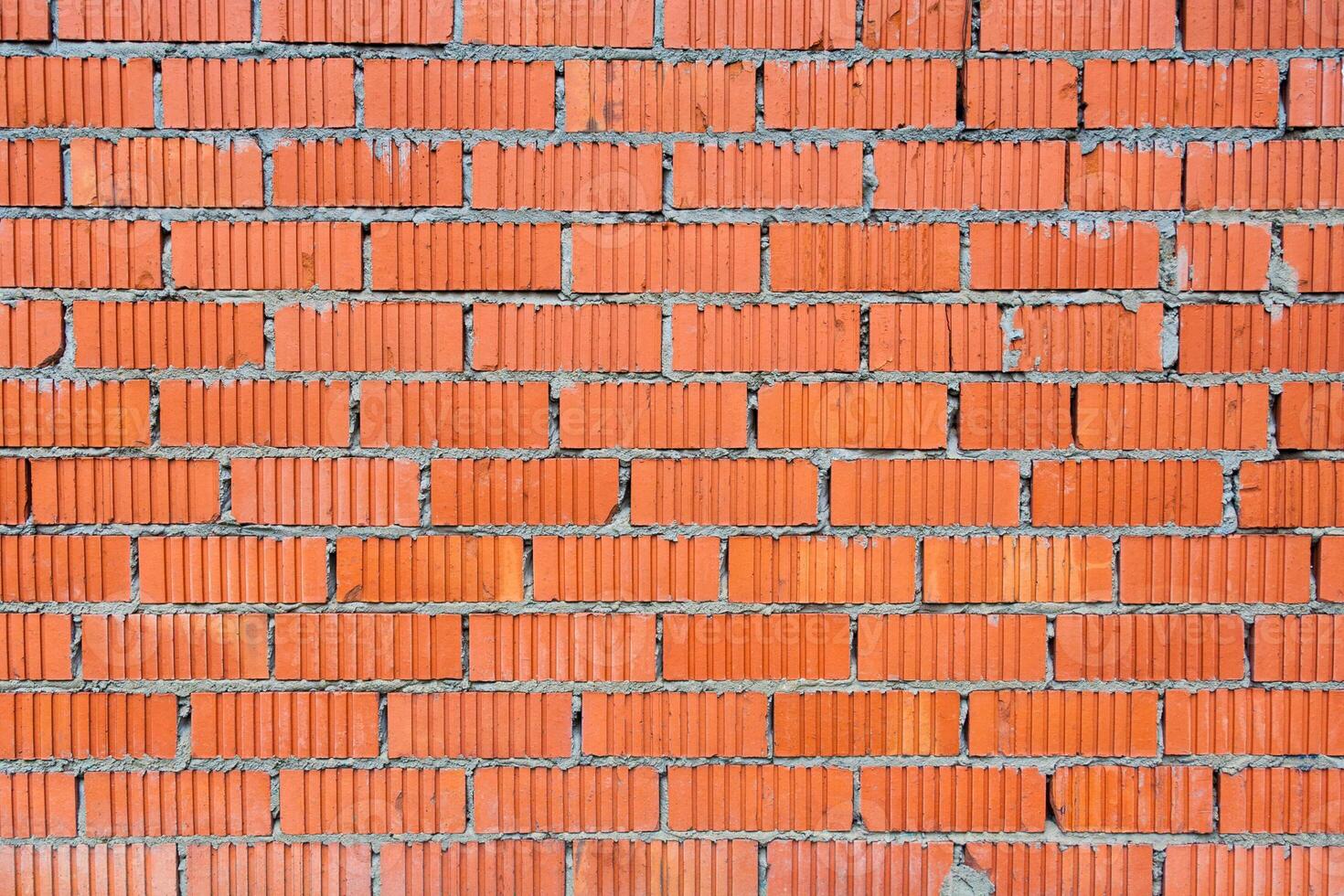 Wall of red brick with fluted texture as background, backdrop photo