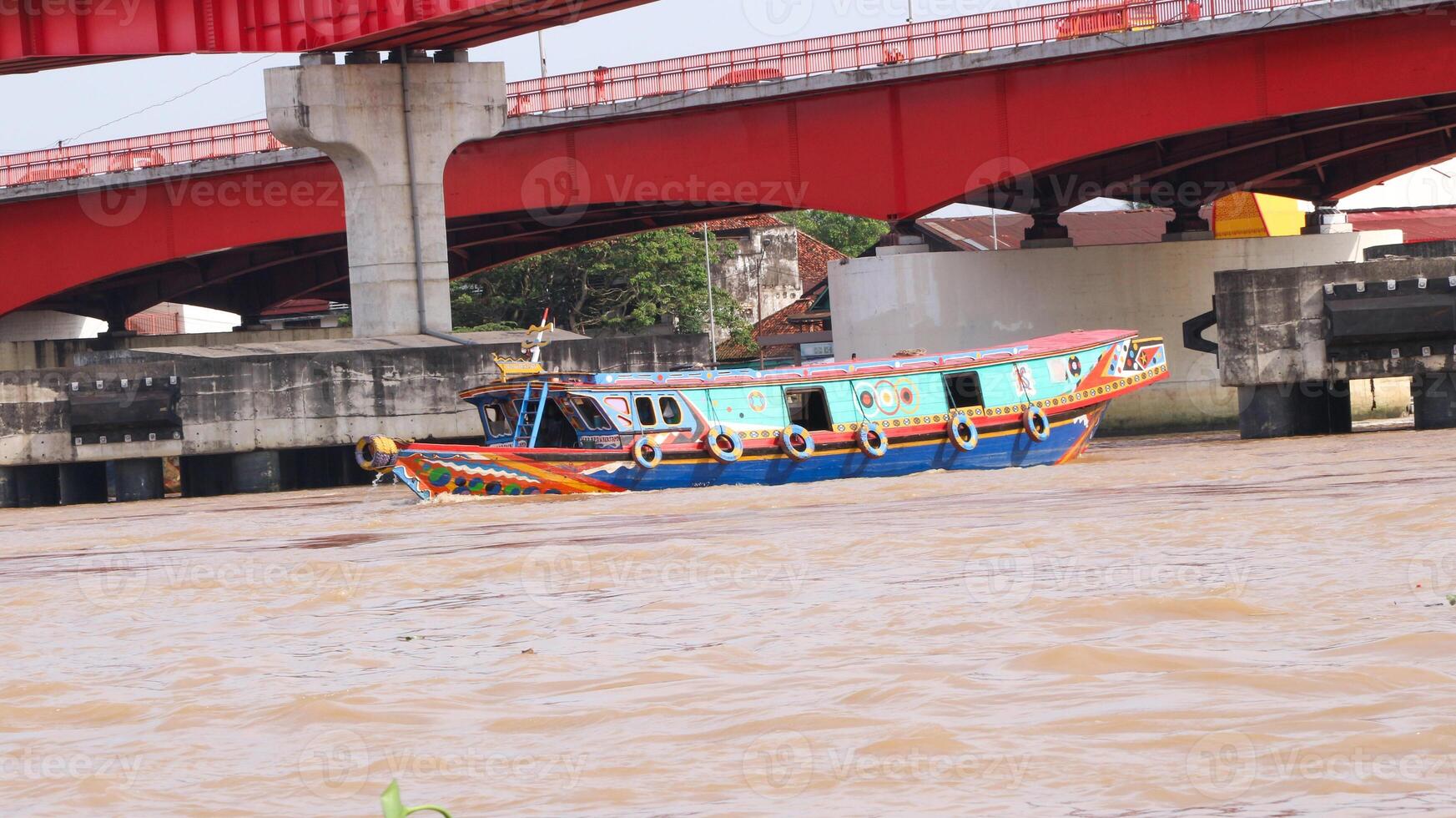 boats carrying goods on the Musi River. famous river in the city of Palembang, South Sumatra, Indonesia. photo