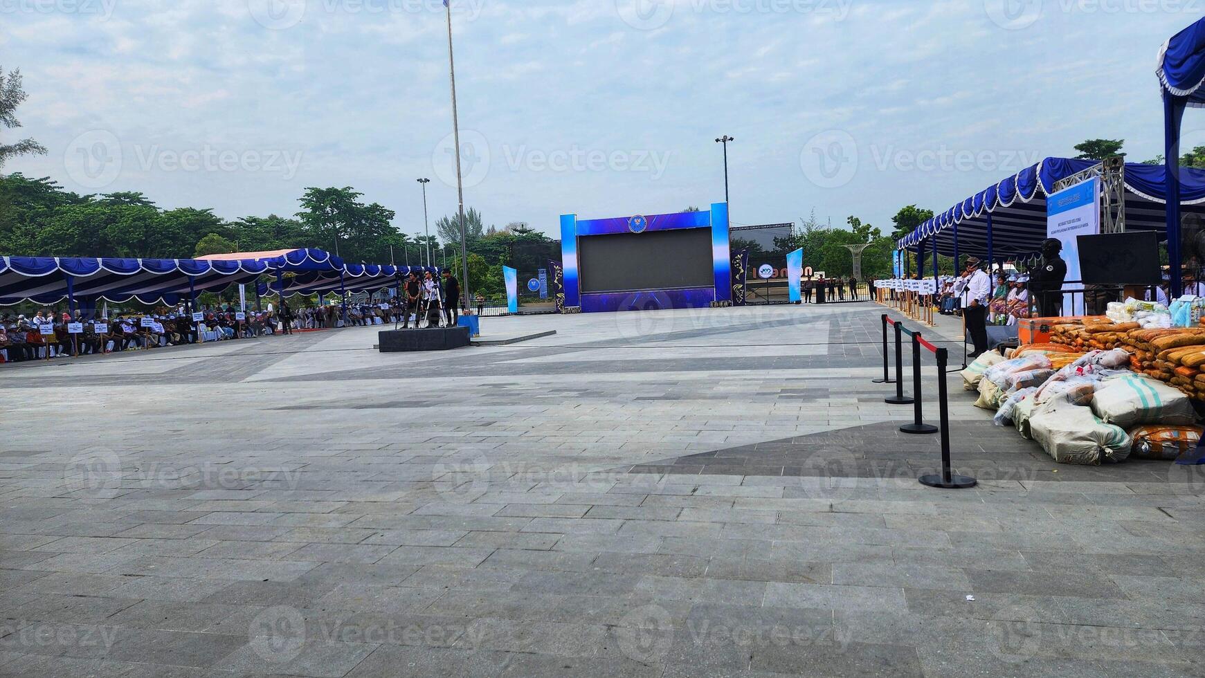 a large outdoor area with people sitting on benches photo