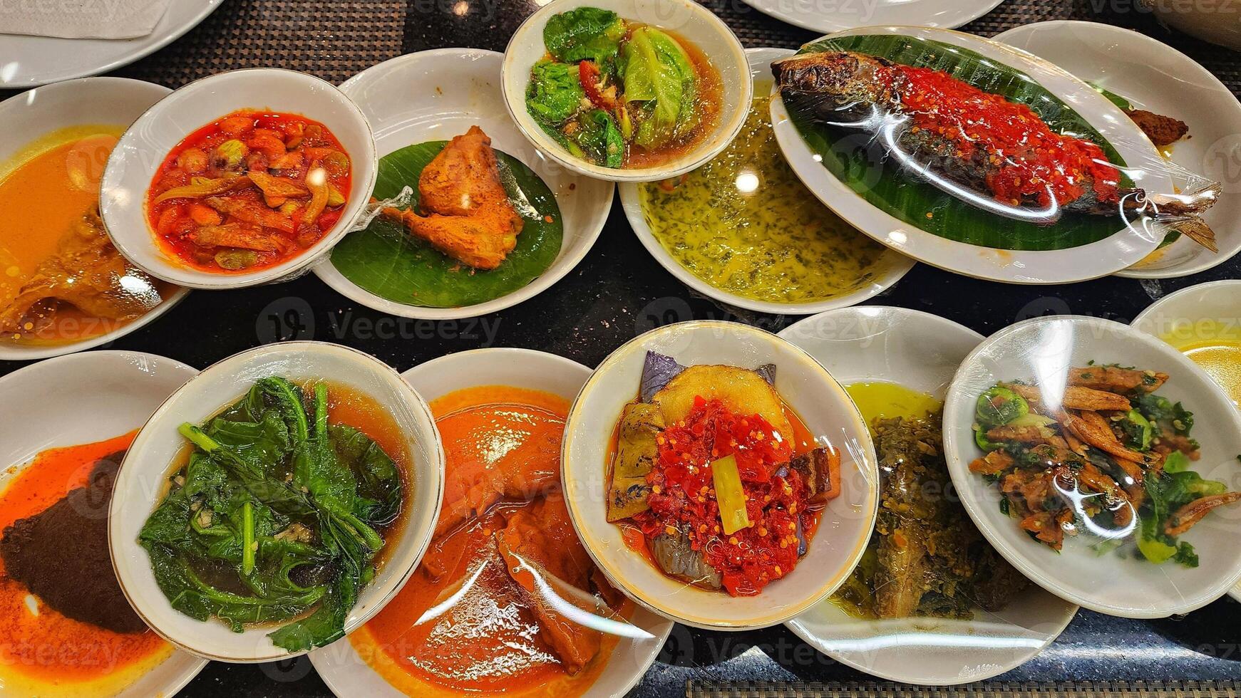 a table with many dishes of food on it photo