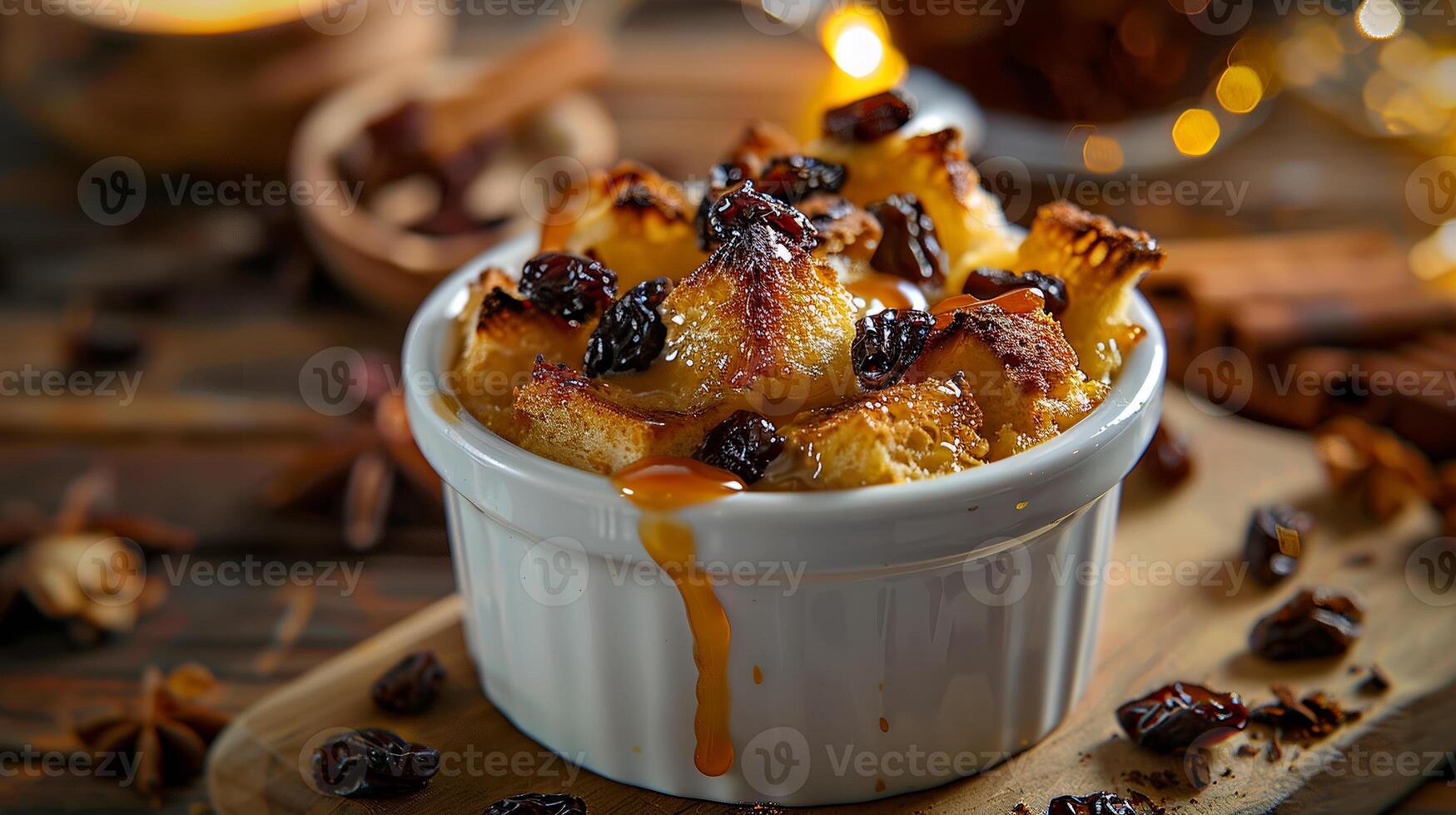 Warm bread pudding with raisins and a bourbon caramel sauce, served in a ramekin. photo