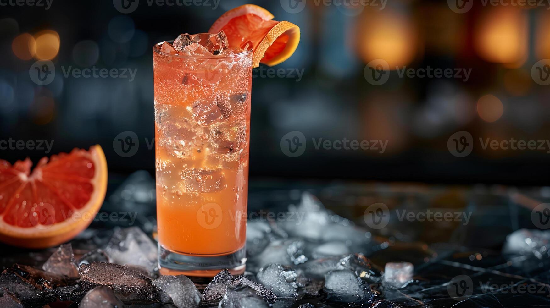 Tangy grapefruit juice served over ice in a highball glass with a grapefruit twist. photo