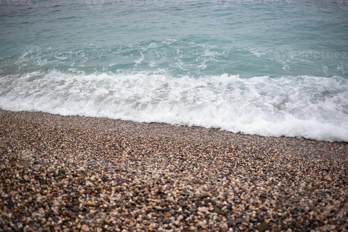 wave on the pebble shore. great background for your design photo