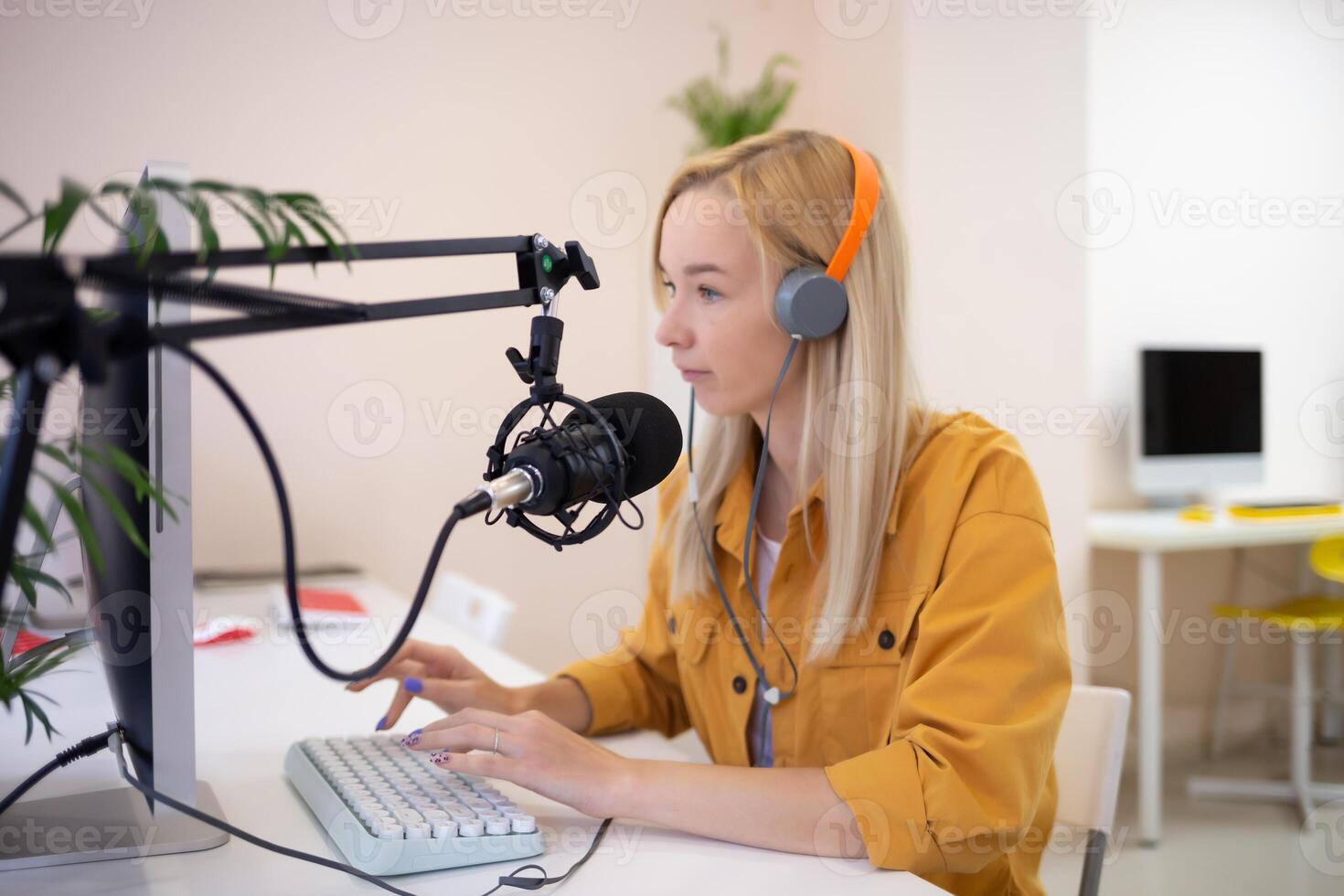 young woman is streaming while sitting in coworking at the computer photo