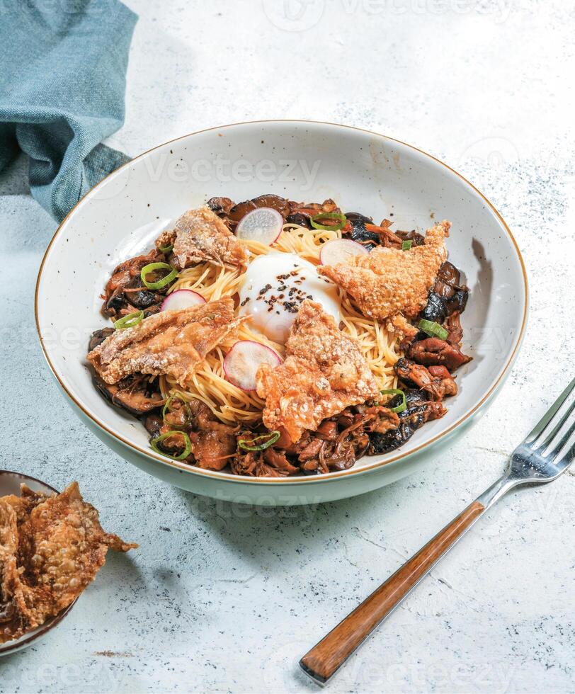 Crispy chicken skin and red radish with soy-braised chicken, sliced mushrooms, sous vide egg photo