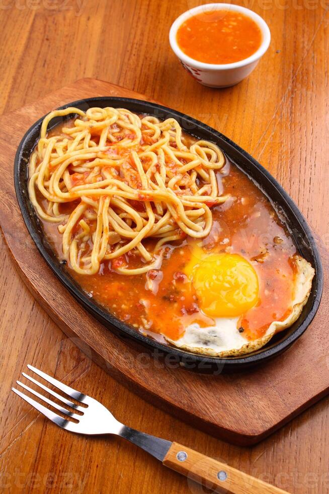 Pasta and fried egg with barbeque sauce photo