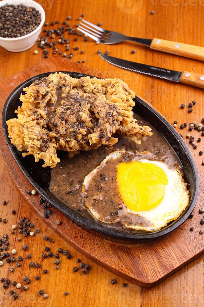 Chicken egg crispy steak with blackpepper sauce photo