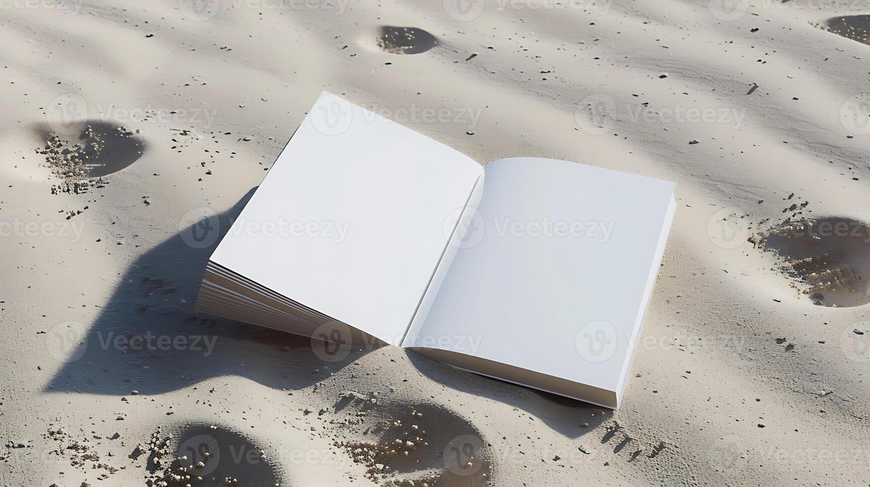Open blank book pages on sandy ground with footprints beach photo