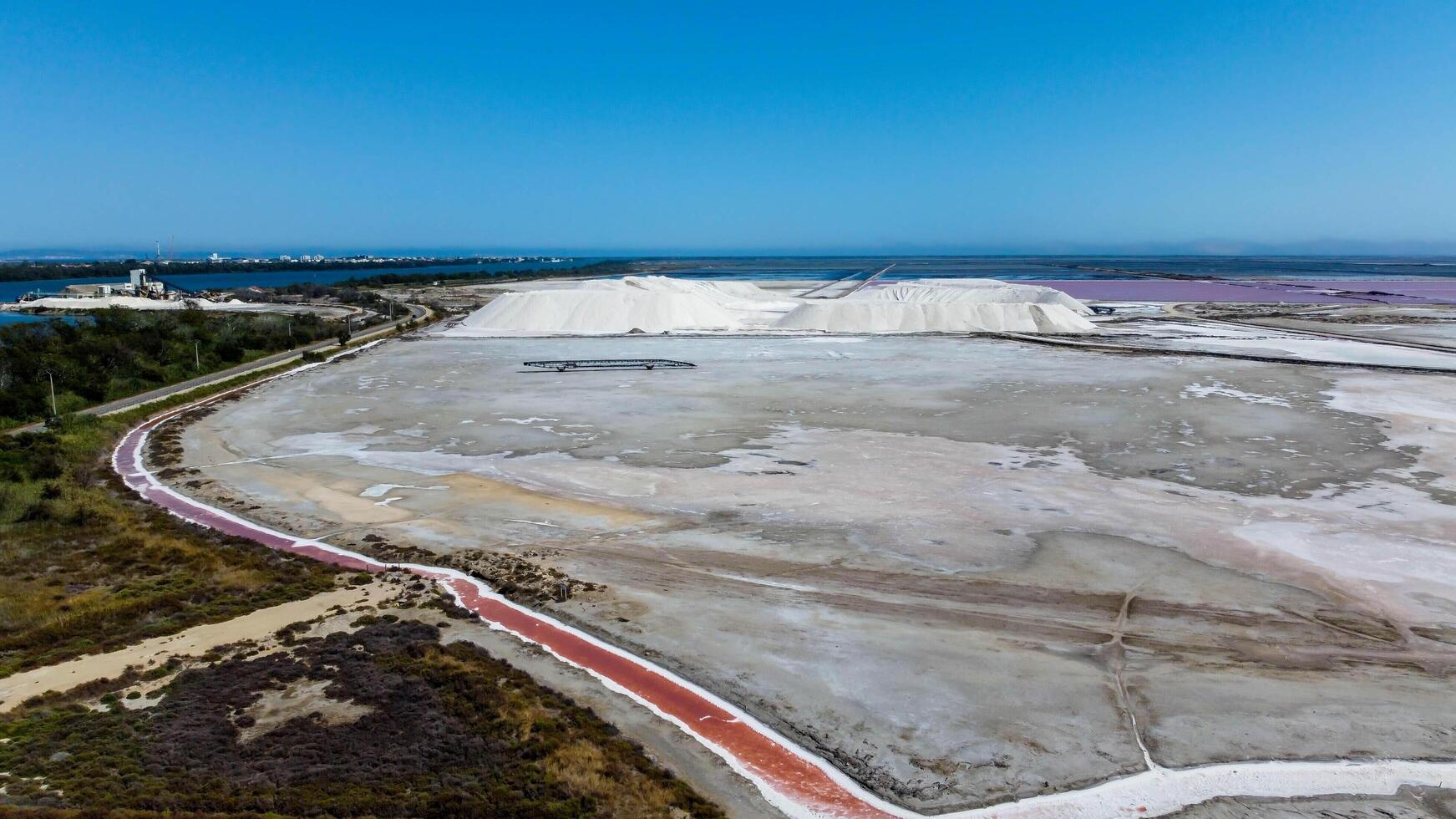 pools of red water rich in salt, tourist attraction of the Giraud salt pans in the Camargue regional natural park in Provence. bright colors captured by a drone. very salty water visited by tourists photo