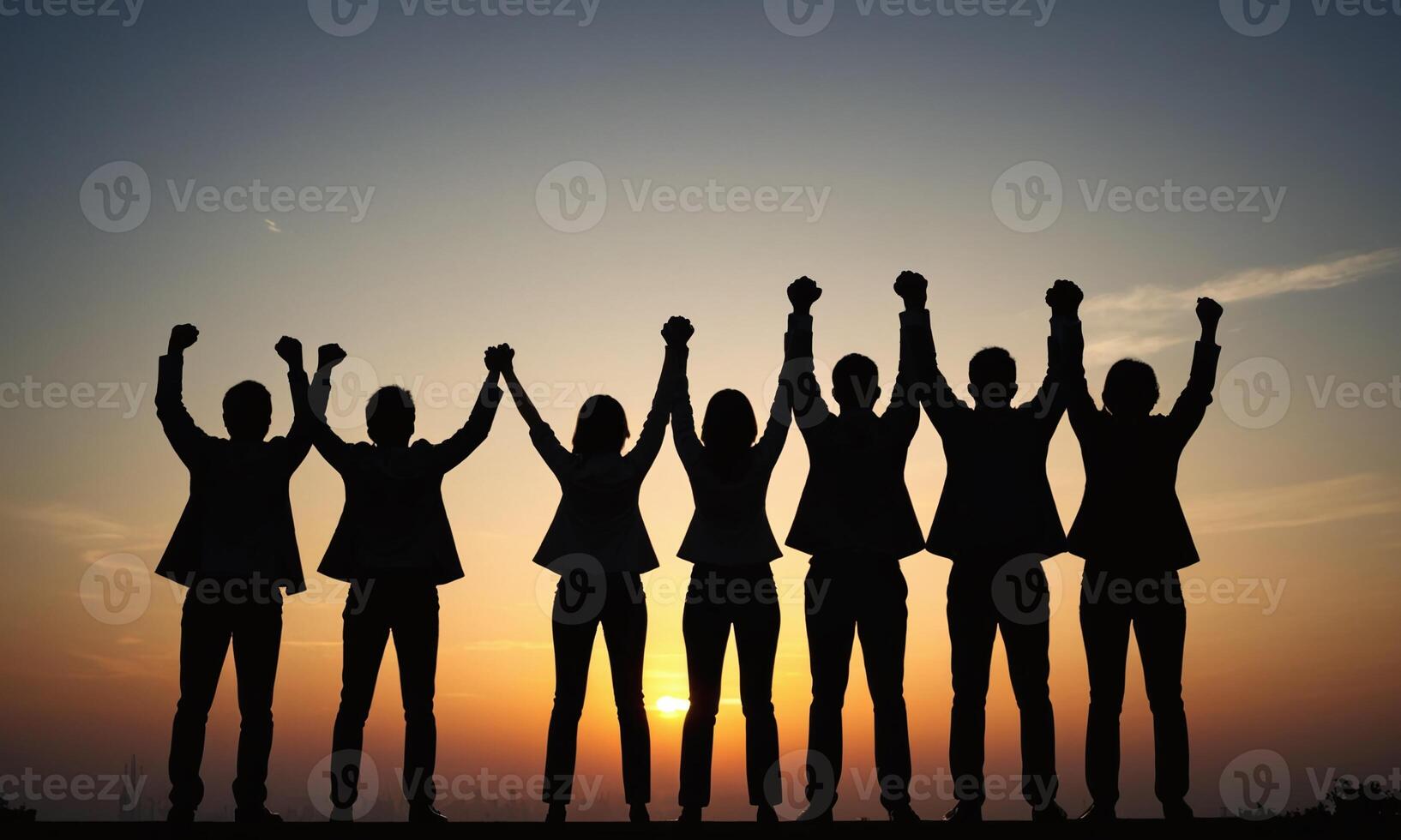 Silhouette of business team stand and feel happy on the most high at stand on sunset photo