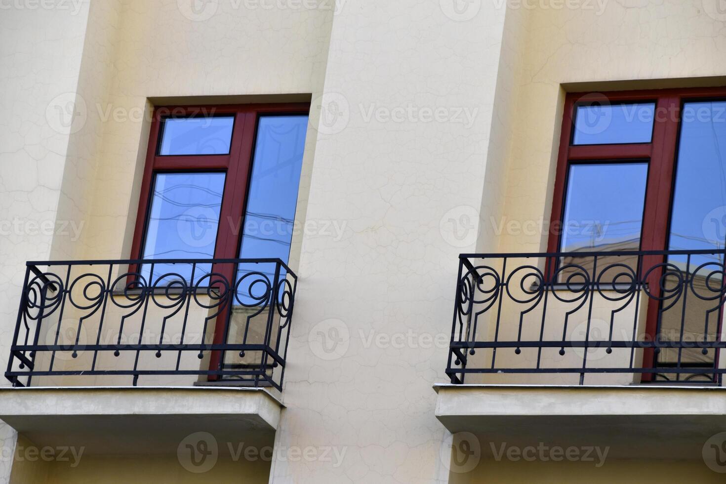 A red window on a yellow wall. A beautiful window in a classic building. photo