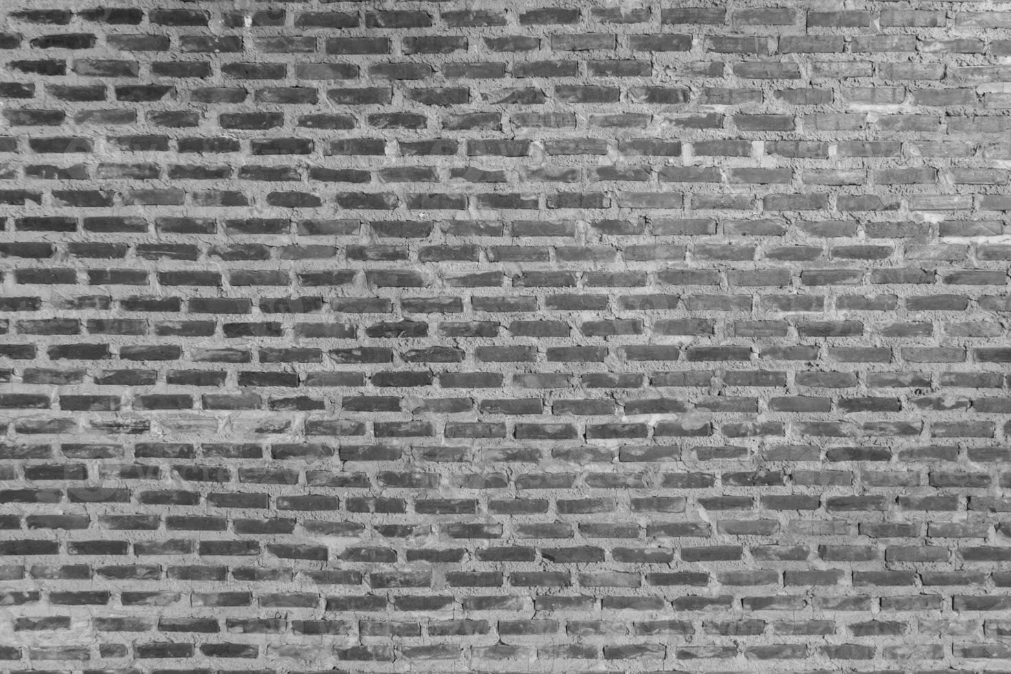 Red brick wall background with uneven texture and varying brick sizes. photo