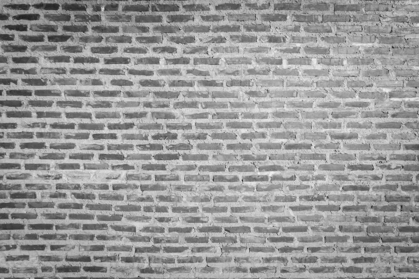 Red brick wall background with uneven texture and varying brick sizes. photo