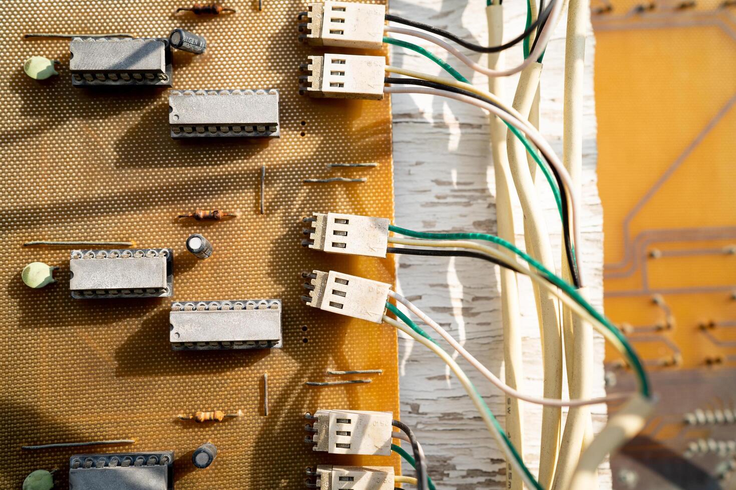 A tangled mess of wires and cords. The wires are all different colors and lengths. Concept of chaos and disorganization photo