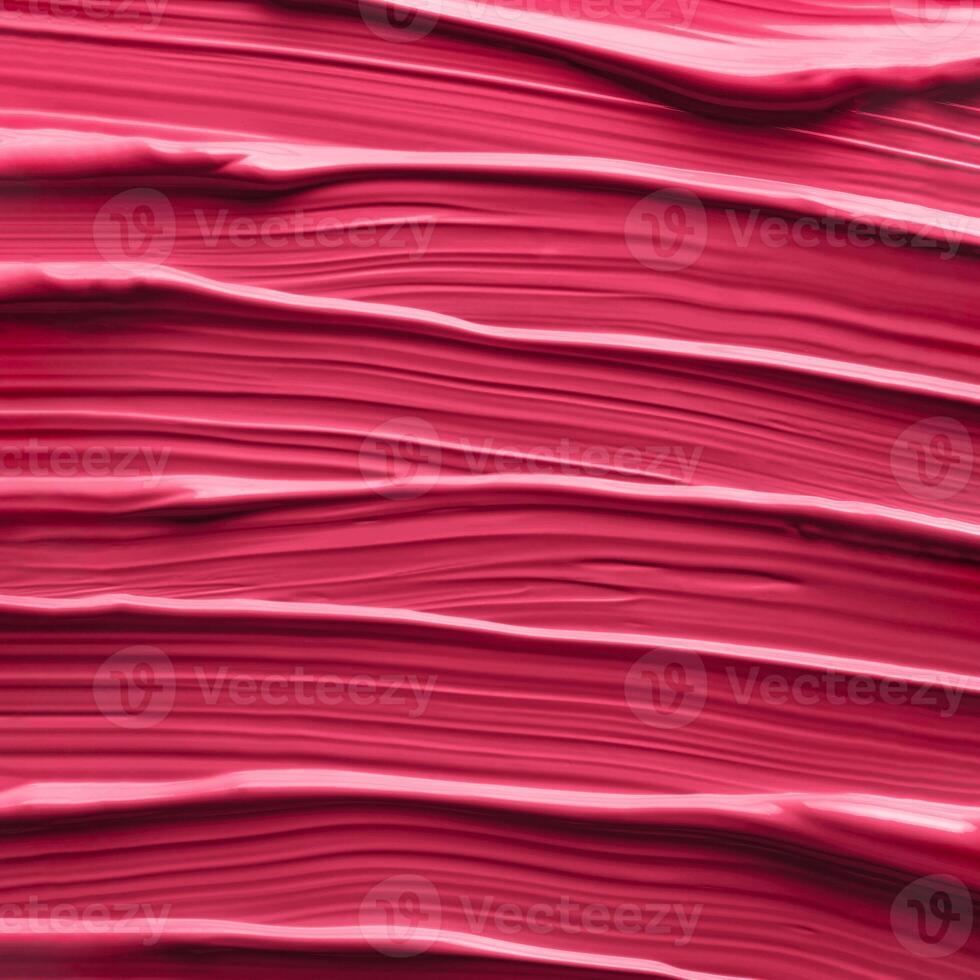 Texture of liquid lipstick in red Viva Magenta red color 2023 as background photo