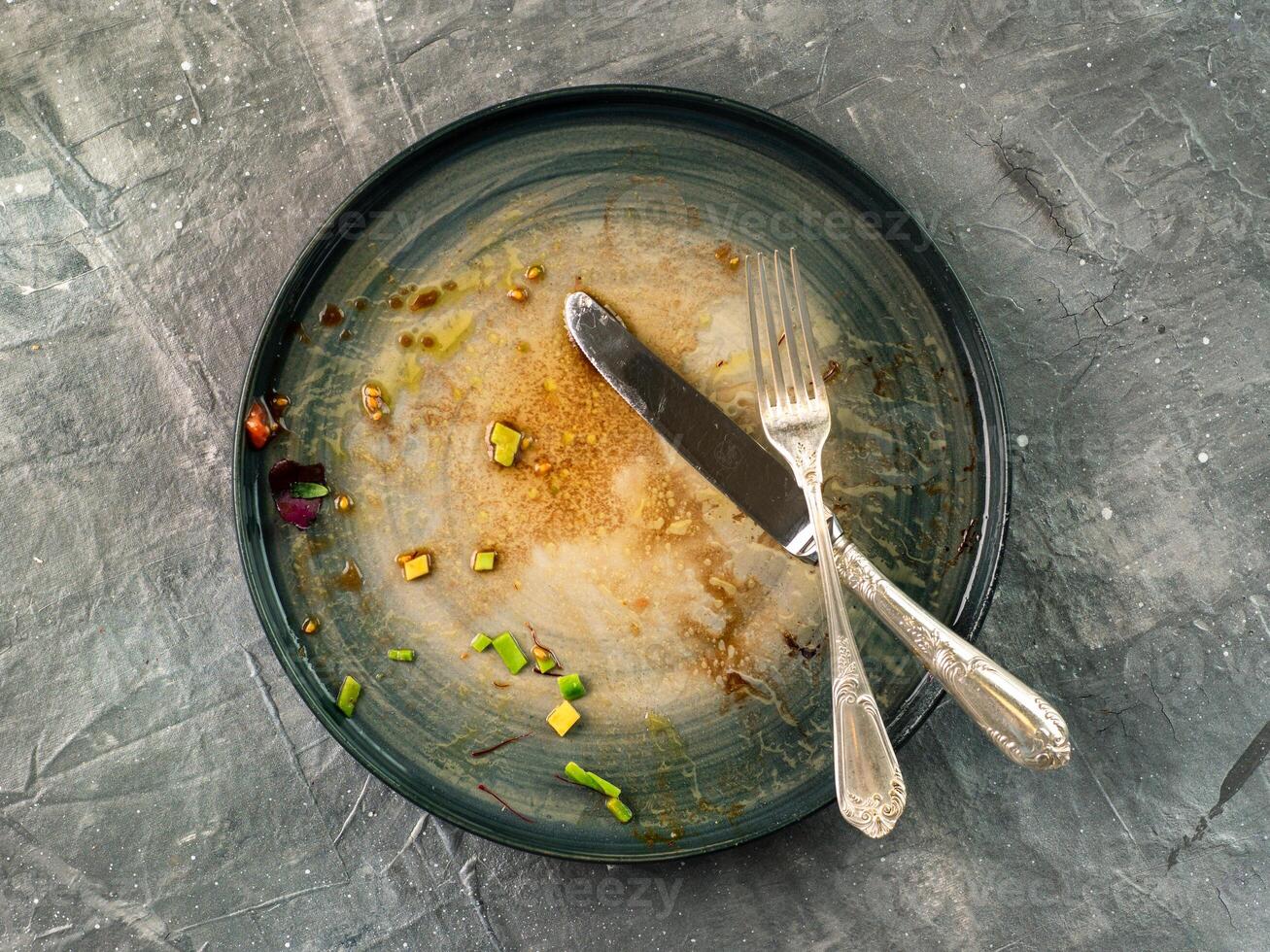 Dirty dish on gray background, top view photo
