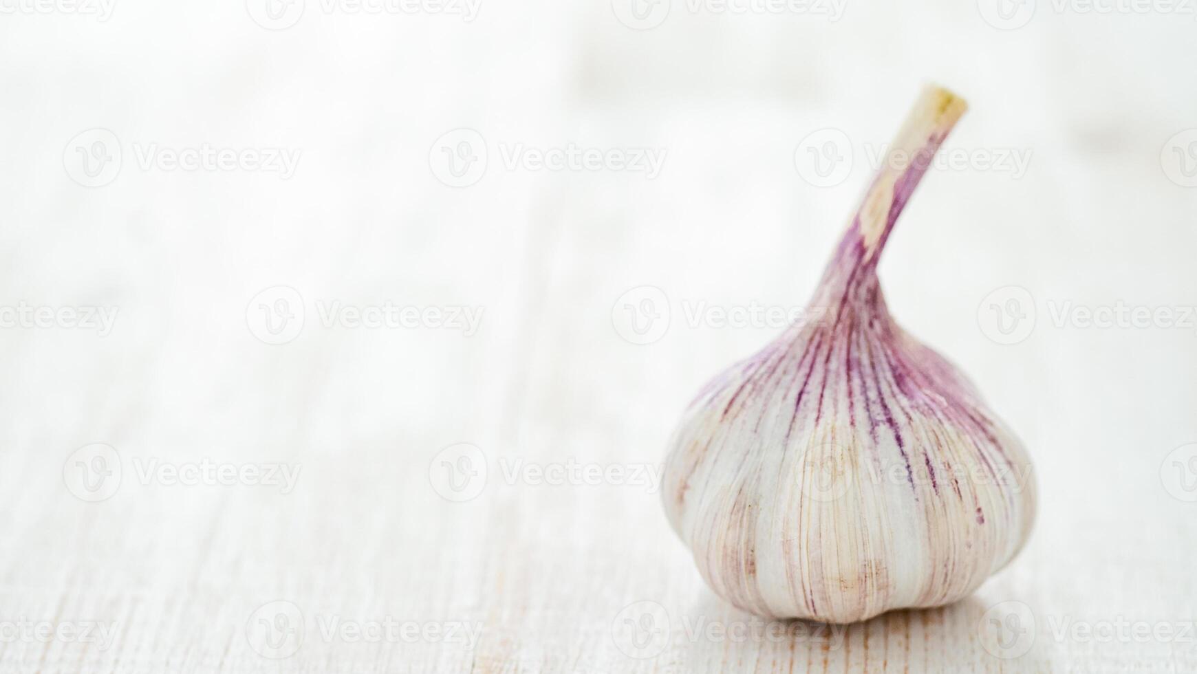 Garlic bulb on white wooden background photo