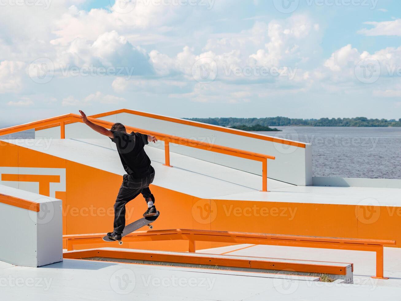 Latino man doing Grind trick on skateboard photo