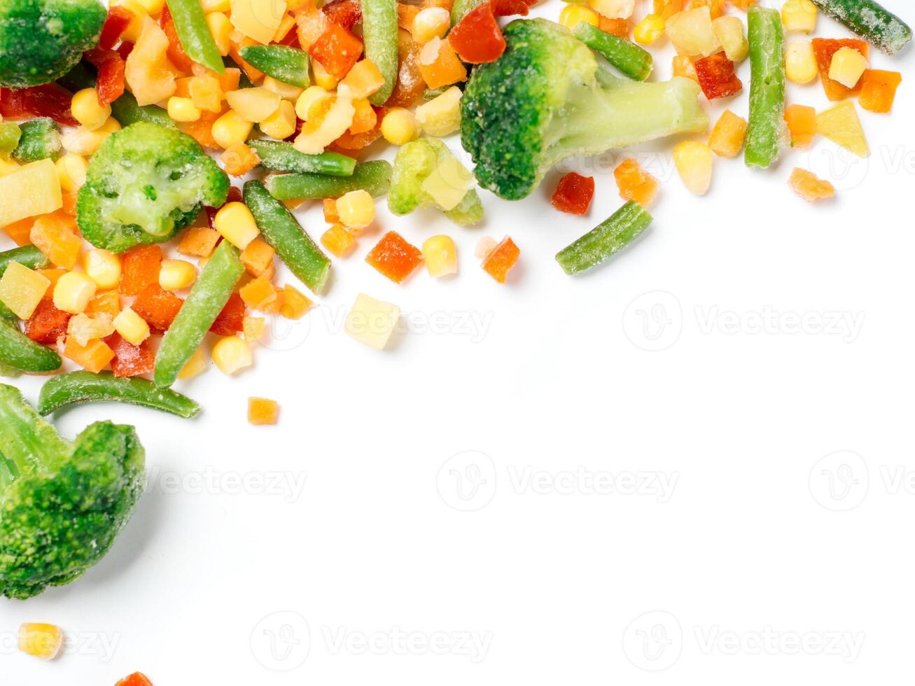 Frozen vegetables assorted isolated on white with clipping path. Frosen vegetables with ice Isolated one edge. Frozen mix vegetables with copy space for text. Top view or flat-lay. photo