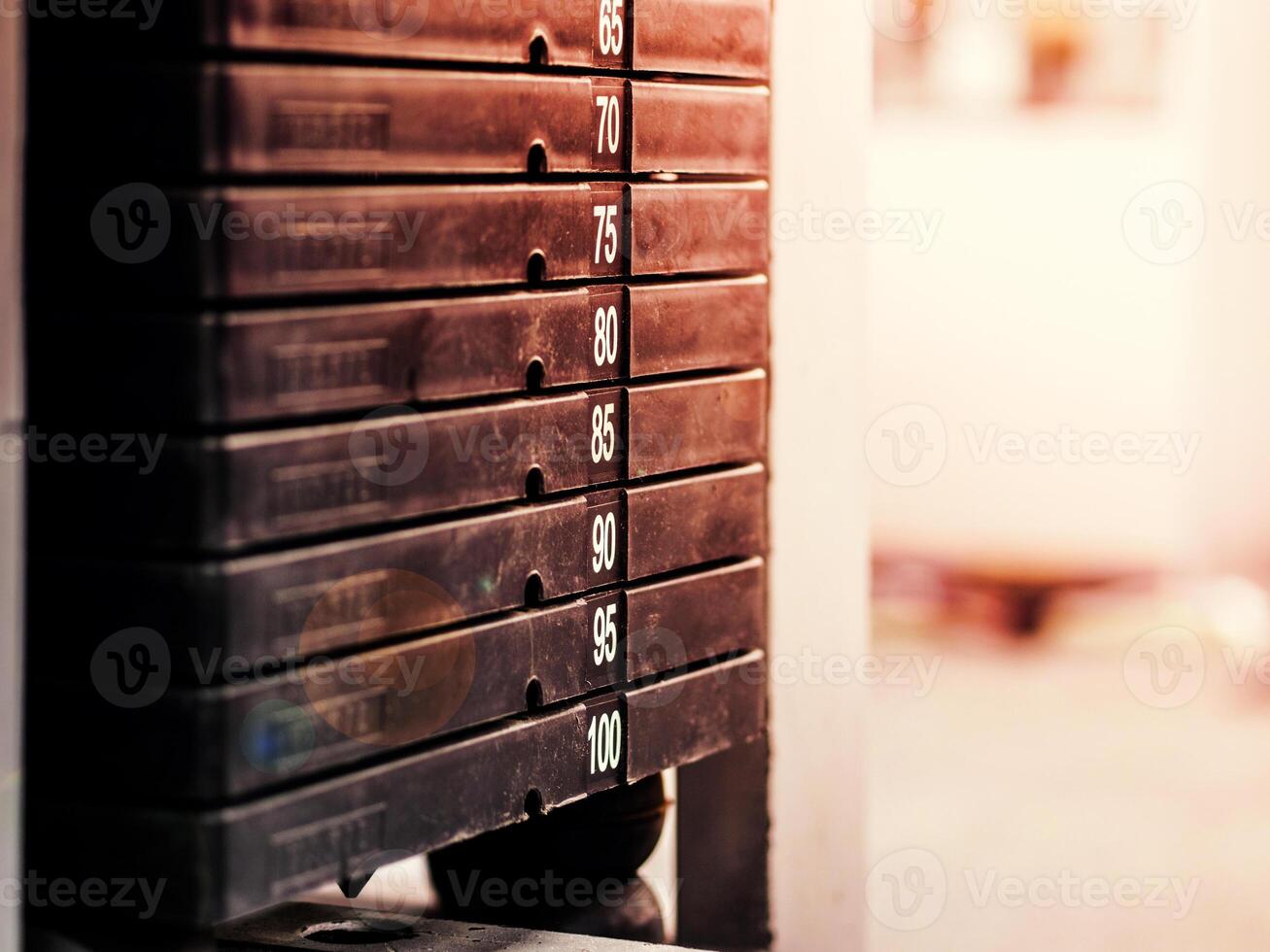 Stack of rusty metal weights in gym bodybuilding equipment photo