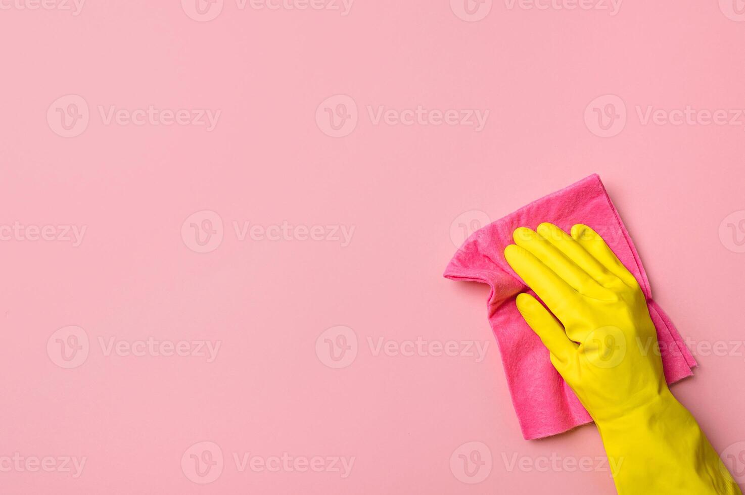 Hand in glove on pink background. Cleaning concept photo