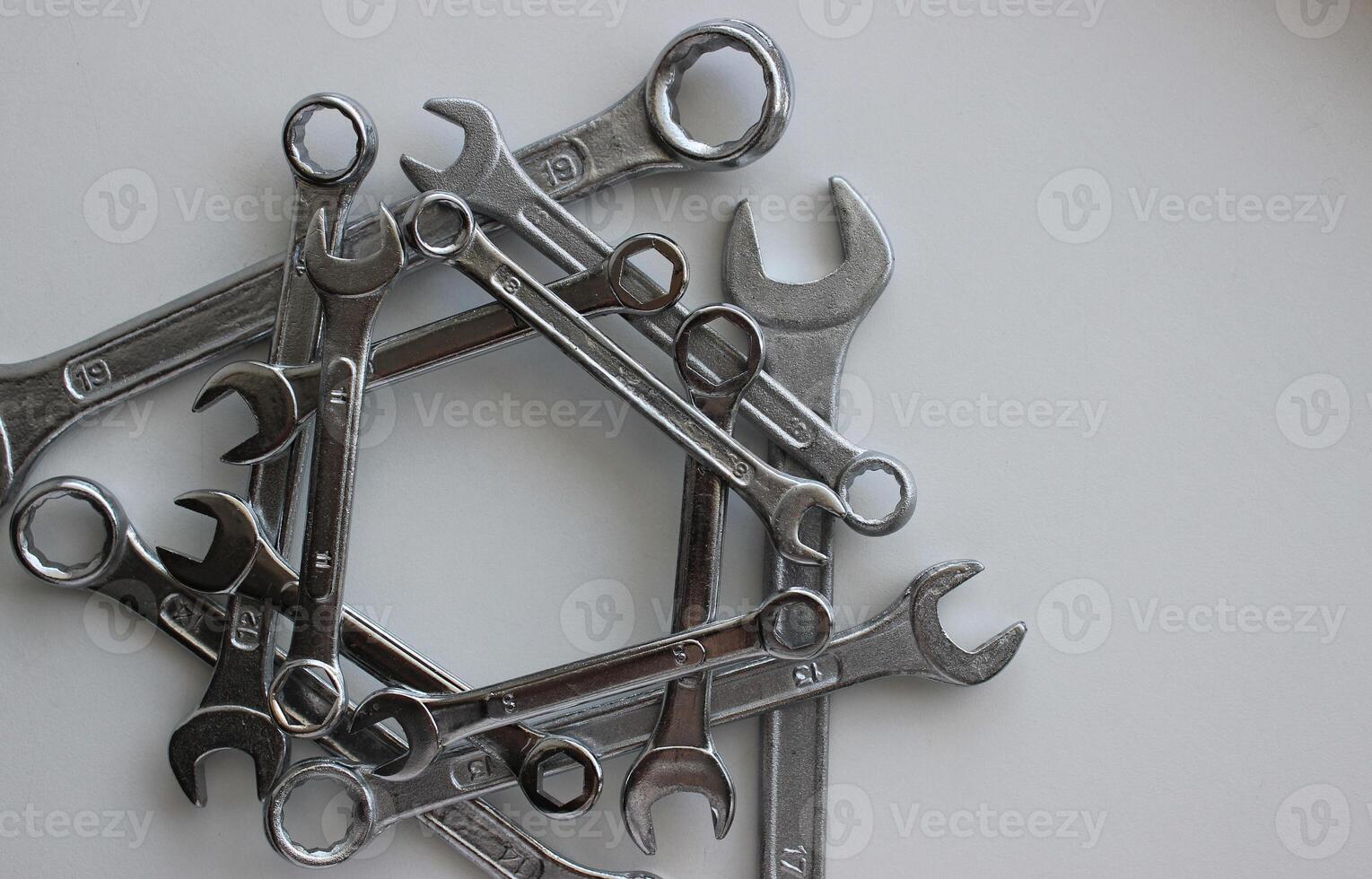 Triangular structure of iron wrenches of different types and diameters isolated on white photo