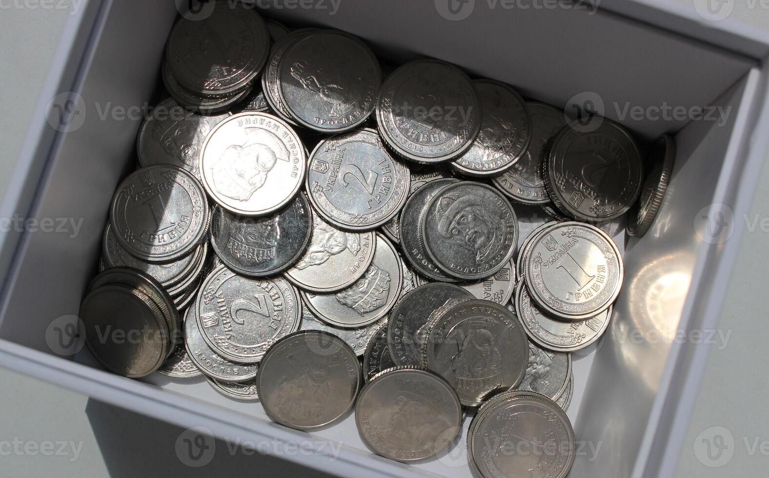 Heap Of Ukrainian Money In Coins At The Bottom Of White Box Closeup View Stock Photo