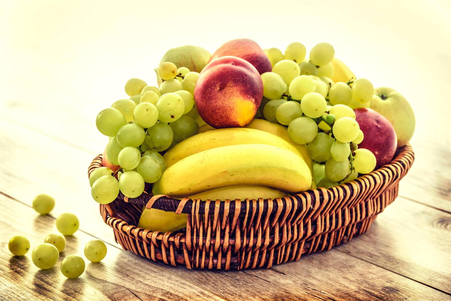 Assortment of fresh exotic fruits and berries on light background photo