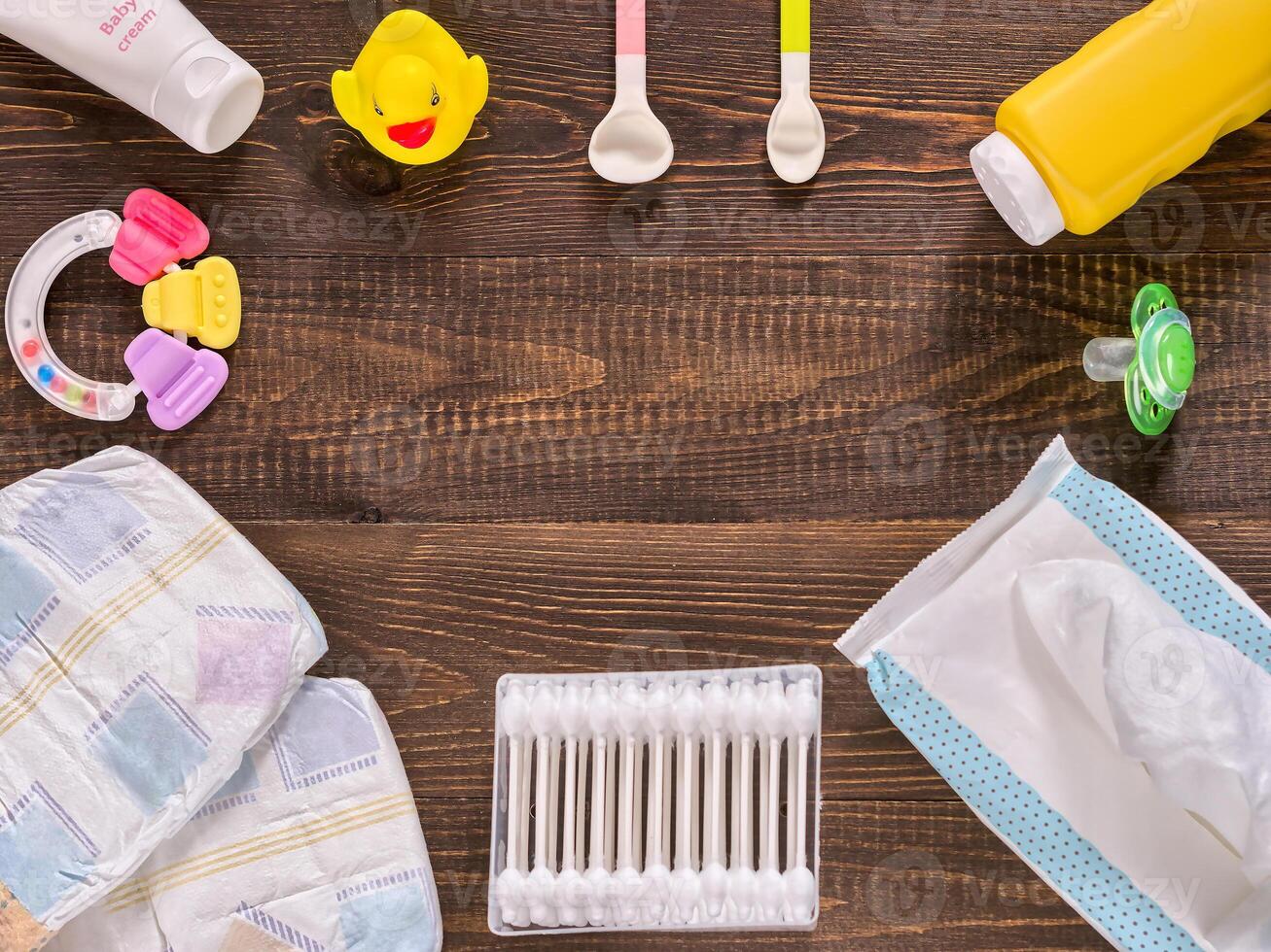 Baby essentials on dark wooden table with copy space photo