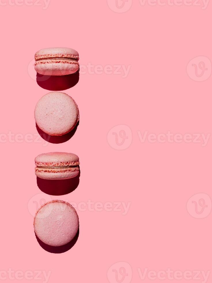 Macarons on pink, copy space, hard light photo