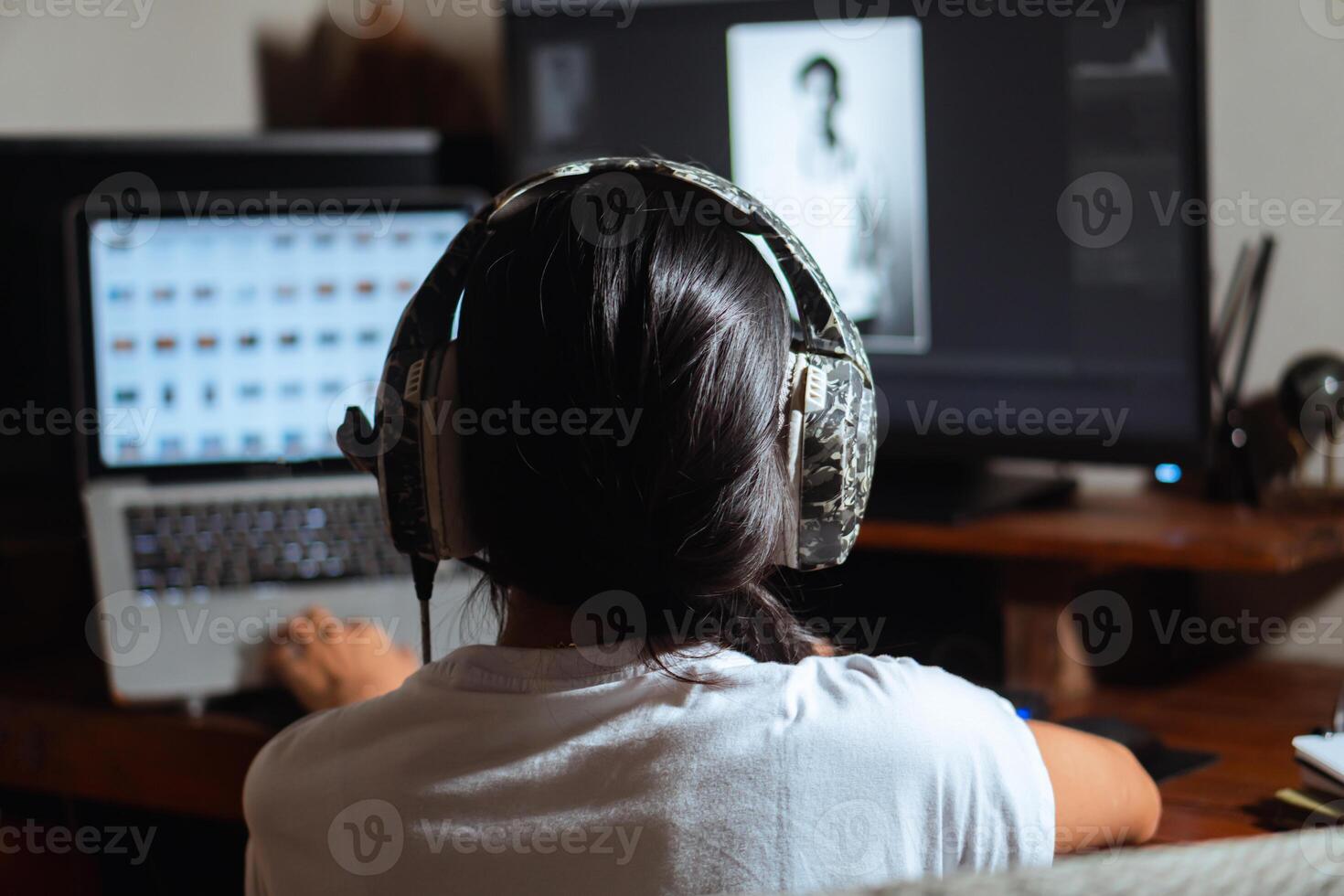Woman with headphones working on photo editing