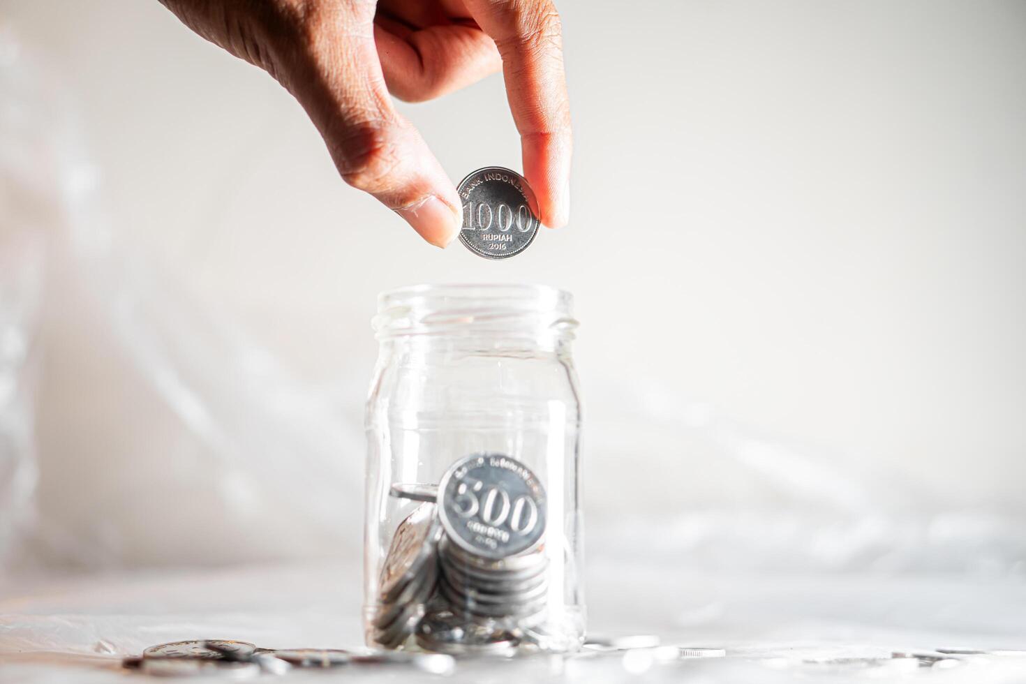 Saving 500 won coins in a glass jar photo