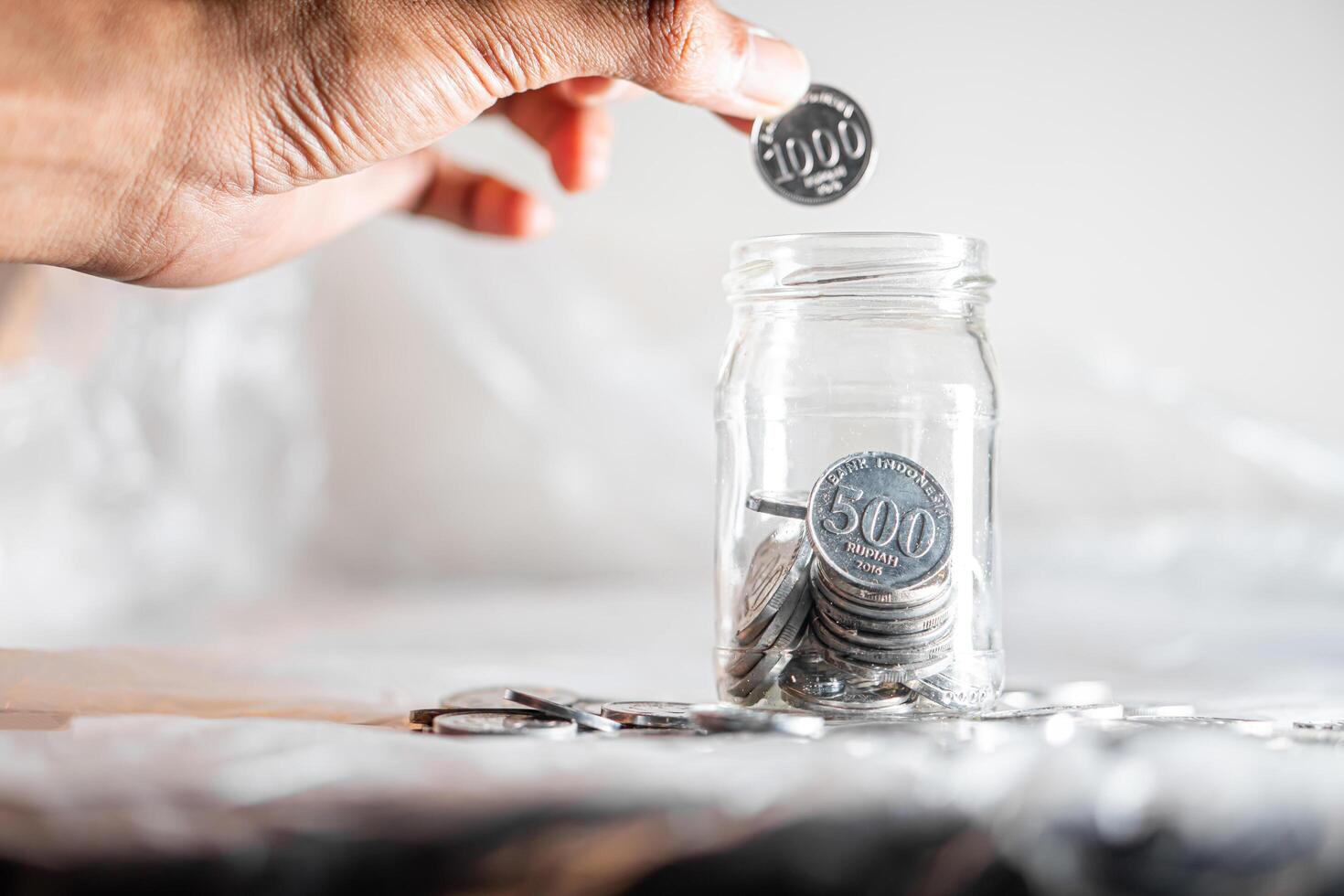 Saving 500 won coins in a glass jar photo