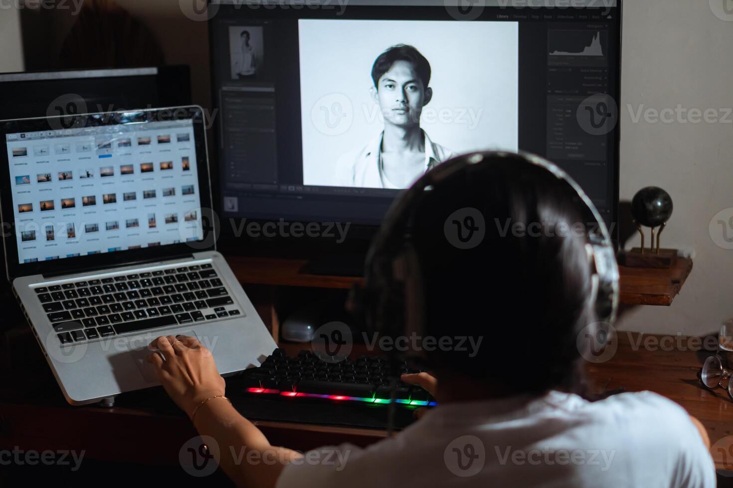 Woman with headphones working on photo editing