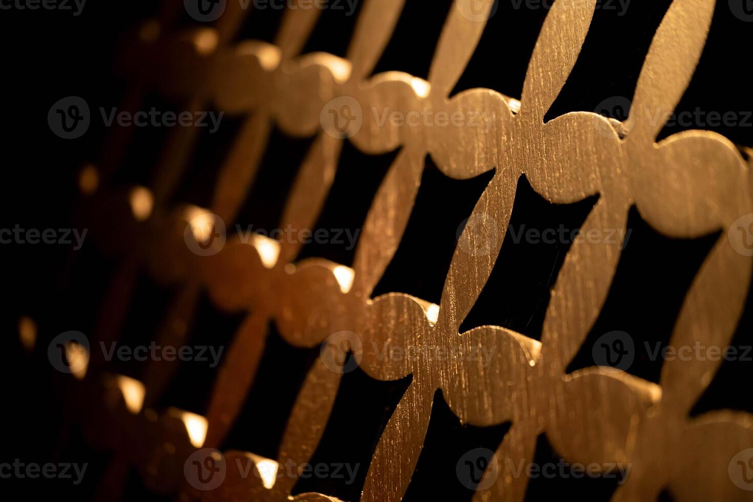 Decorative golden metal grid with repeating pattern photo