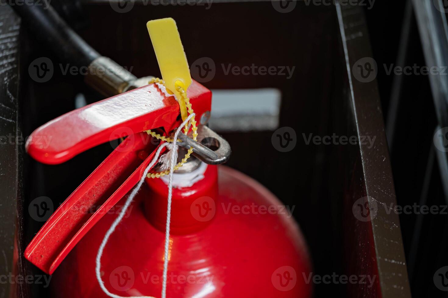 Red fire extinguisher with safety seal in compartment photo