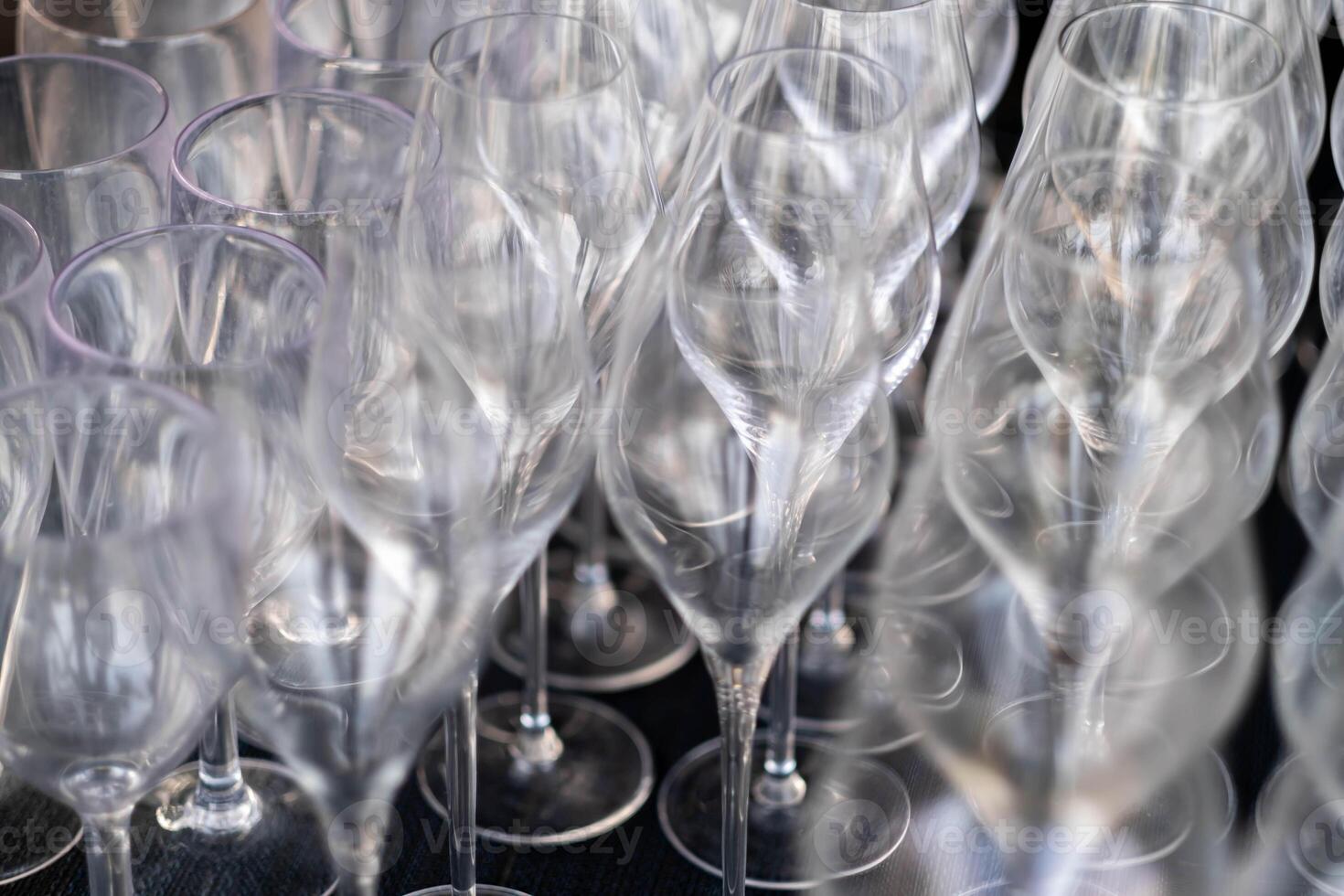 Close-up of empty wine glasses arranged in a pattern photo