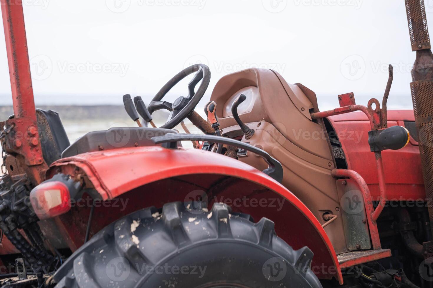 Old red tractor close-up photo