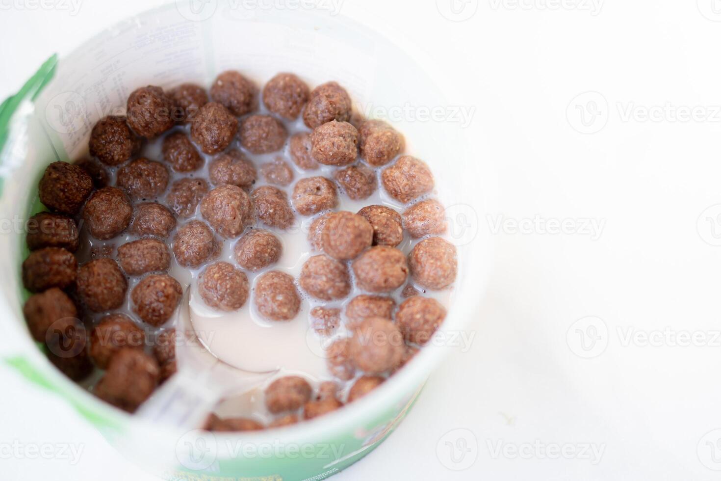 Chocolate cereal balls with milk in a bowl photo