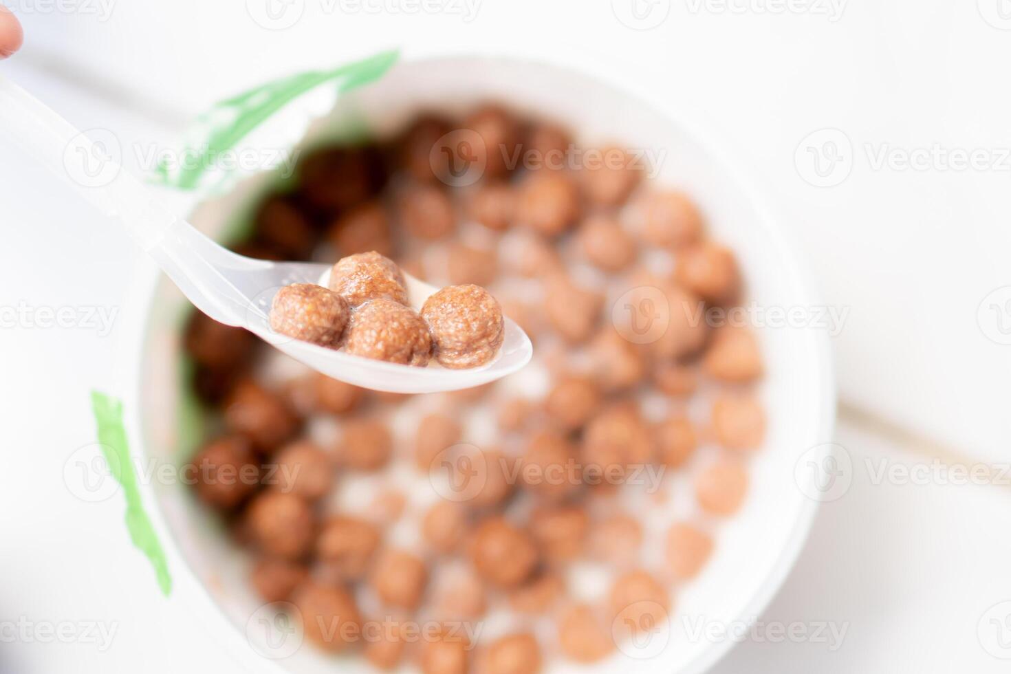 Chocolate cereal balls with milk in a bowl photo