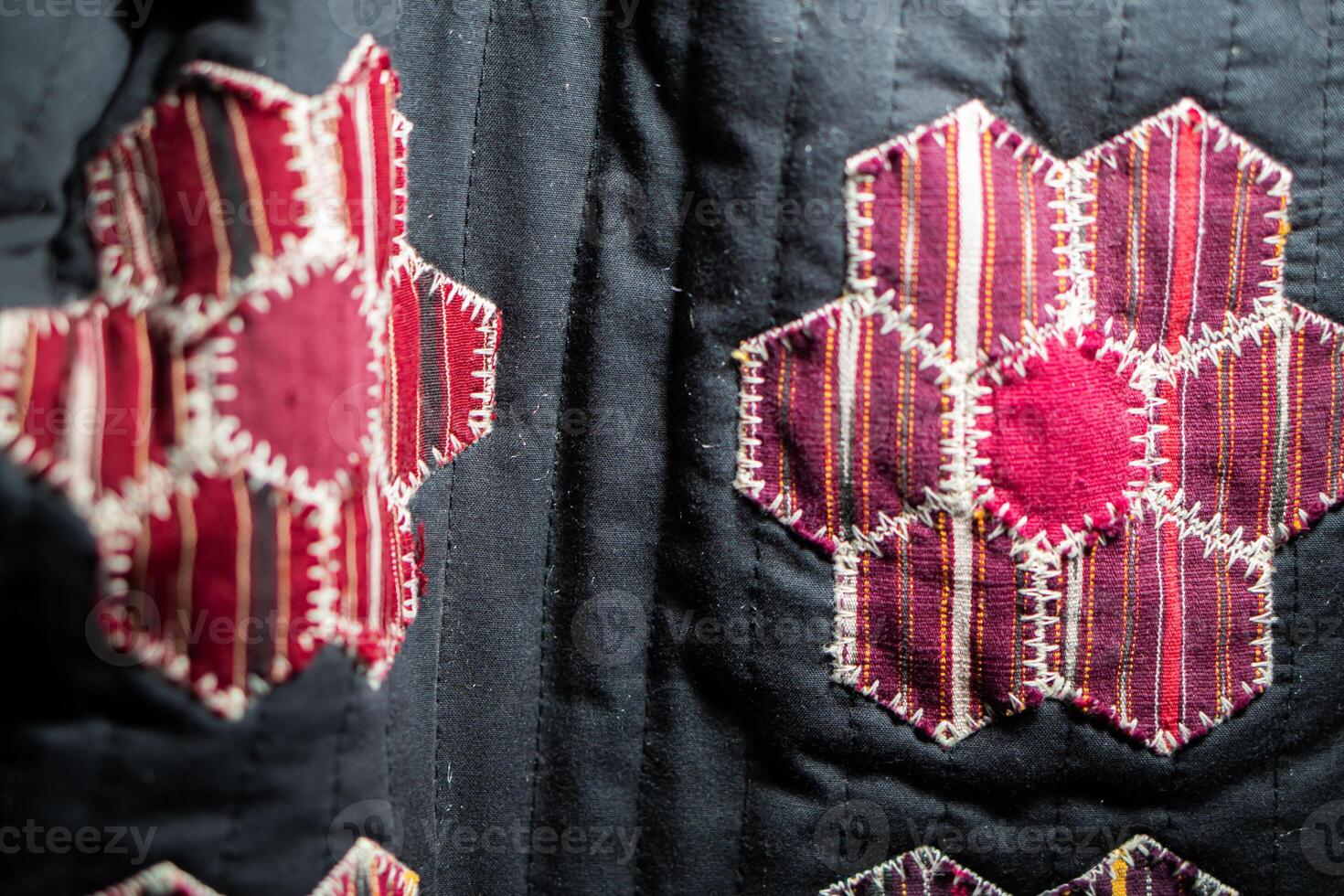 Quilt with red and pink hexagonal patchwork patterns photo