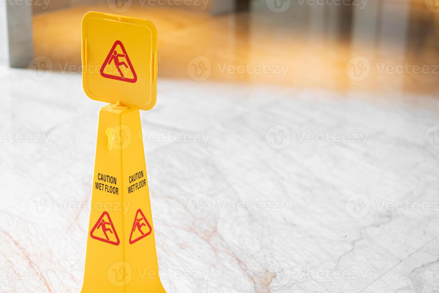 Yellow caution wet floor sign on marble floor photo
