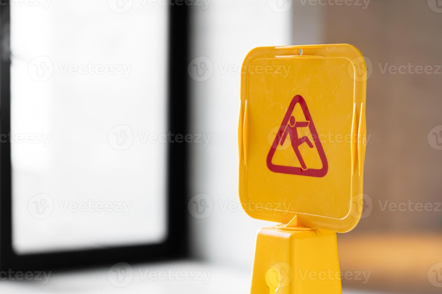 Yellow caution wet floor sign on marble floor photo