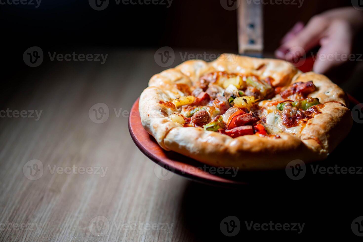 Freshly baked pizza on a wooden paddle photo