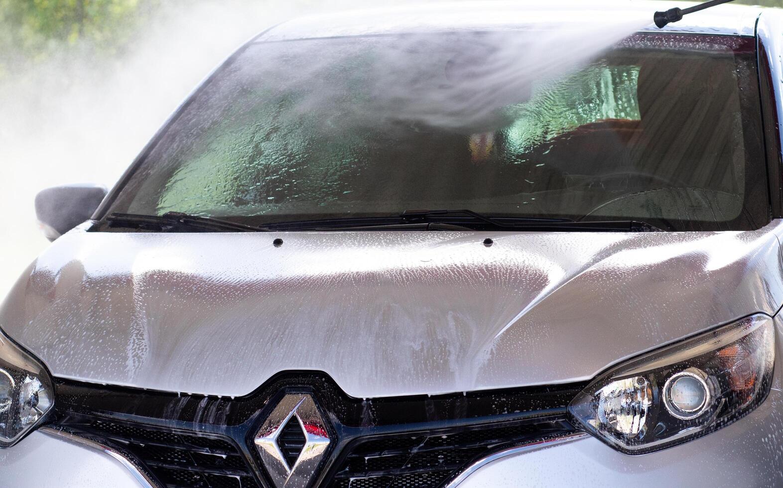 Grodno, Belarus - 06.01.2020 Washing a silver Renault Kaptur or Captur car on the first day of summer photo