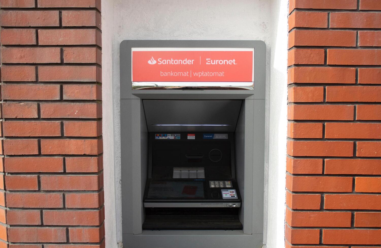 Poznan, Poland - 04.14.2024 Santander ATM installed on the street close-up photo