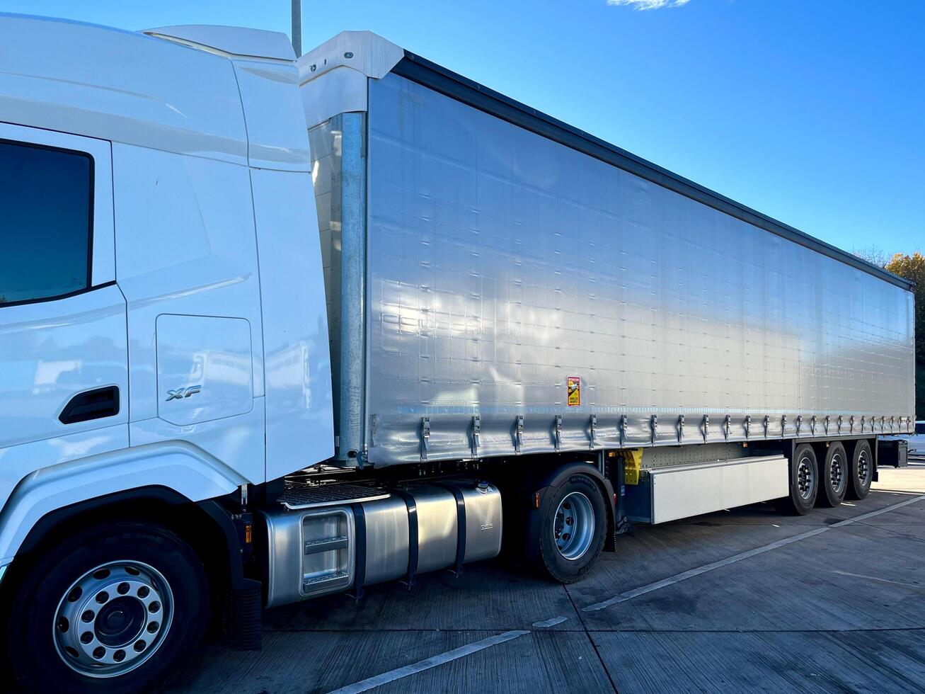 Poznan, Poland 01.03.2023 New DAF XF truck with schmitz curtain trailer photo