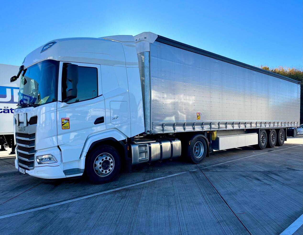 Poznan, Poland 01.03.2023 New DAF XF truck with schmitz curtain trailer photo
