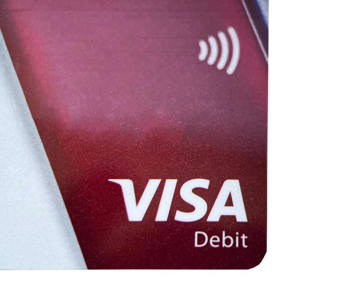 Poznan, Poland - 10.26.2022 Red Visa bank card for payments on a white isolated background photo